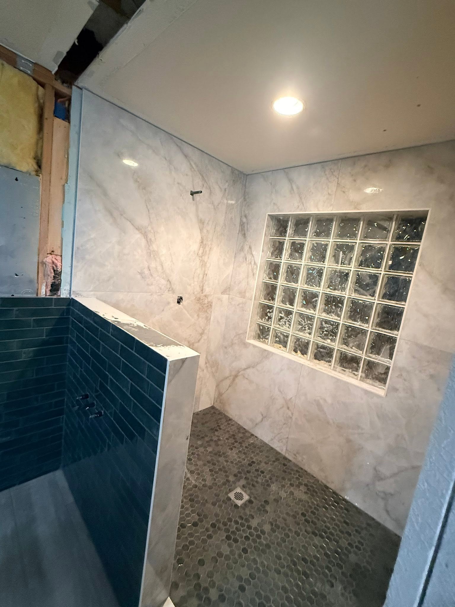 Shower remodel with marble herringbone tile